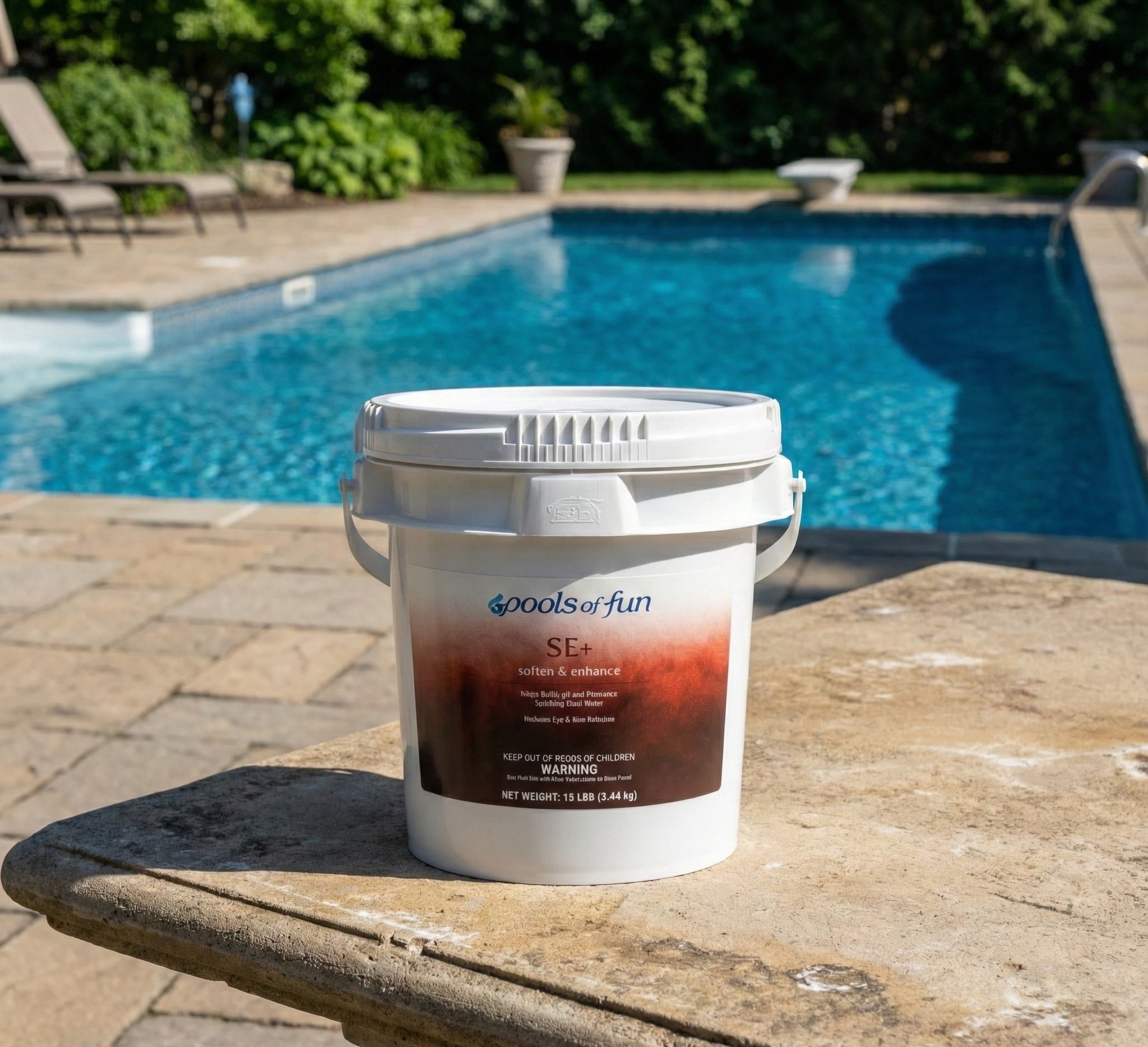 A bucket of pool chemical on a table by a pool
